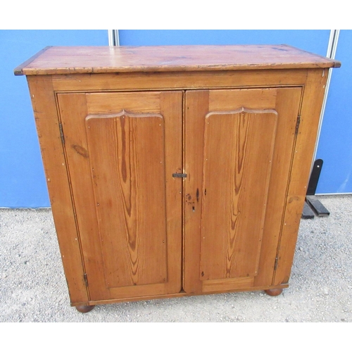 1304 - Waxed pine kitchen cupboard, moulded top and two raised panel doors, on bun turned feet, W103cm D51c... 