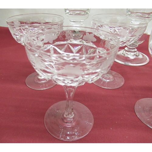 1125 - Pair of large wine glasses, the tapering bowls etched with fruiting vine, single knop stem encasing ... 