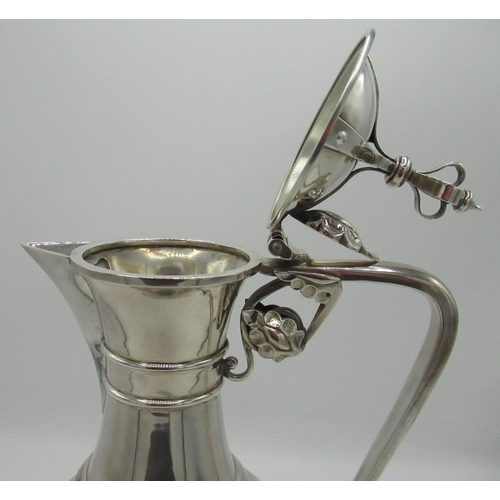 1046 - Geo.V hallmarked silver Communion wine ewer, hinged lid with crown finial, angular handle with leaf ... 