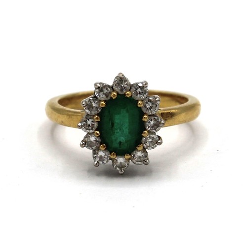 1025 - 18ct yellow gold diamond and emerald cluster ring, the central oval cut emerald surrounded by a halo... 