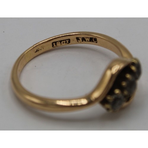 1019 - 18ct gold ring, crossover set with three diamonds, stamped 18ct, size P, gross3.5g