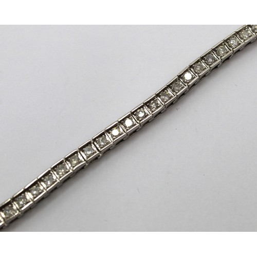 1001 - 14ct white gold tennis bracelet set with fifty three brilliant cut diamonds, L19cm, stamped 14k, 13.... 