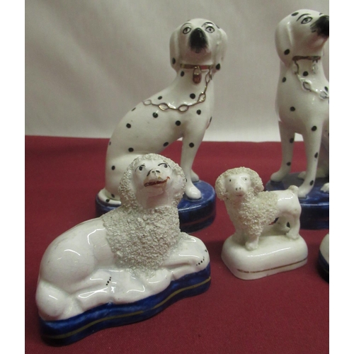 1135 - Pair of small Staffordshire Spaniels, another pair with black spotted markings, gilt collars and cha... 