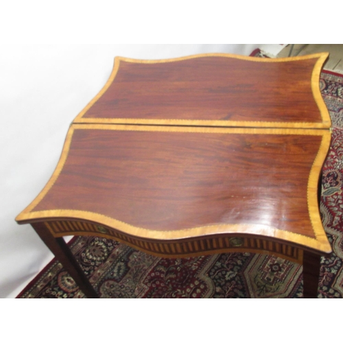 1310 - Geo. III inlaid mahogany folding tea table, serpentine top with satinwood cross band , and inlaid fr... 