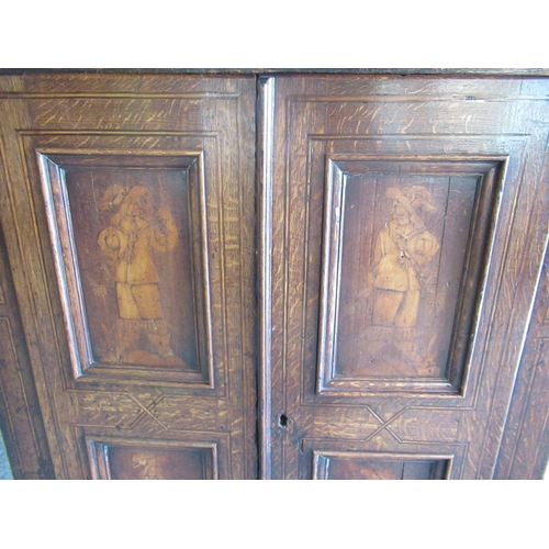 1320 - Early C19th Dutch ebonised strung oak side cabinet, the moulded top above two doors with four figura... 