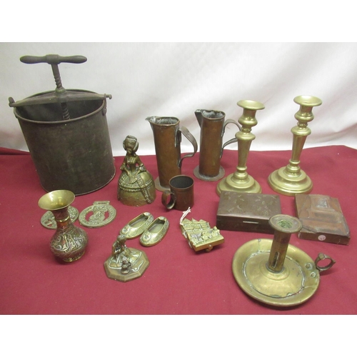 272 - Metal fruit press, two brass candlesticks, brass chamberstick, Arnold and Sons copper Dariol mould w... 