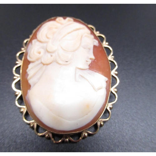29 - C20th shell cameo brooch of a young woman in profile on 9ct yellow gold mount, and another smaller s... 