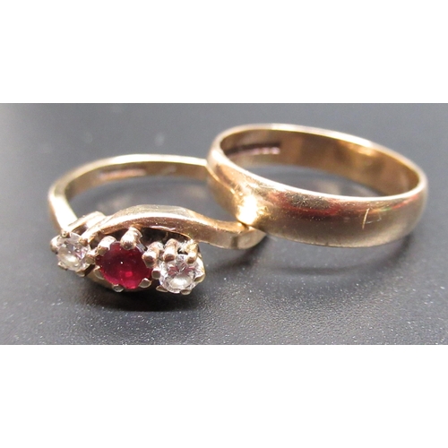31 - 9ct yellow gold diamond and ruby crossover ring, set with a central brilliant cut ruby and two brill... 