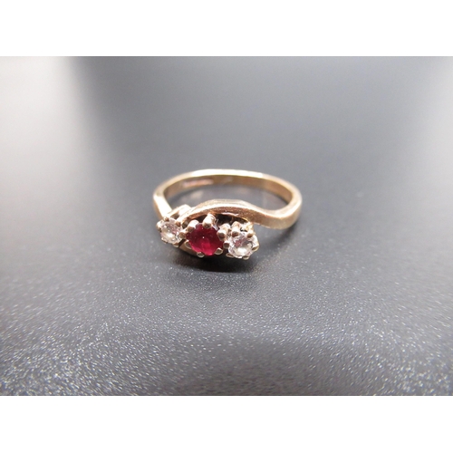 31 - 9ct yellow gold diamond and ruby crossover ring, set with a central brilliant cut ruby and two brill... 