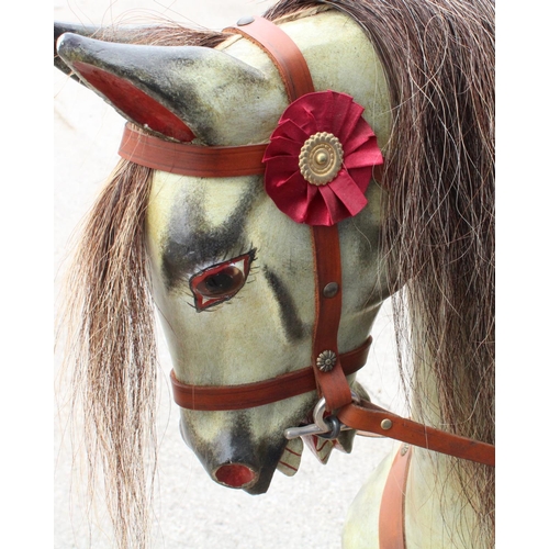 868 - C20th rocking horse in dapple grey coat with brindle plume and tail, leather saddle and stirrups wit... 