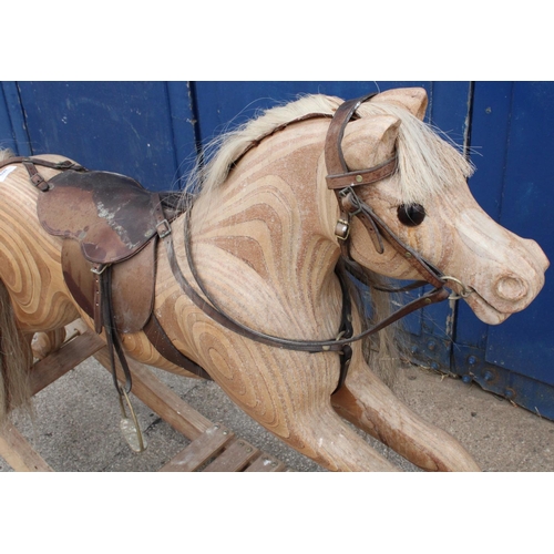 869 - C20th rocking horse, ply construction on bow rocker base, cream mane and tail with leather saddle, b... 