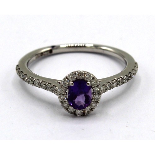 247 - 9ct white gold amethyst and diamond cluster ring, the oval cut amethyst surrounded by a halo of bril... 