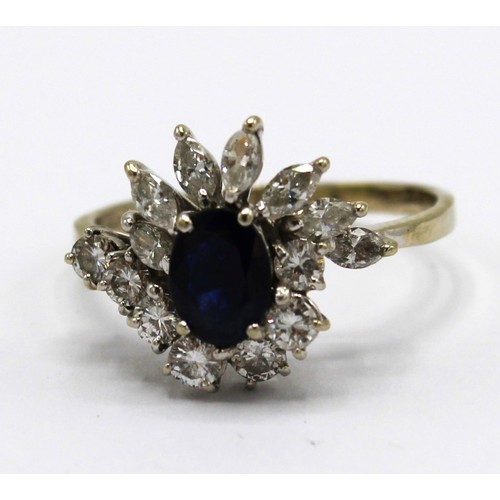 253 - 18ct white gold sapphire and diamond cluster ring, the central oval cut sapphire surrounded by seven... 