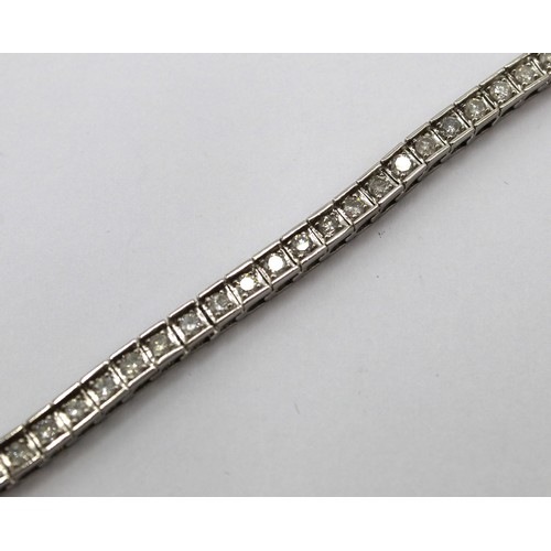 254 - 14ct white gold tennis bracelet set with fifty three brilliant cut diamonds, L19cm, stamped 14k, 13.... 