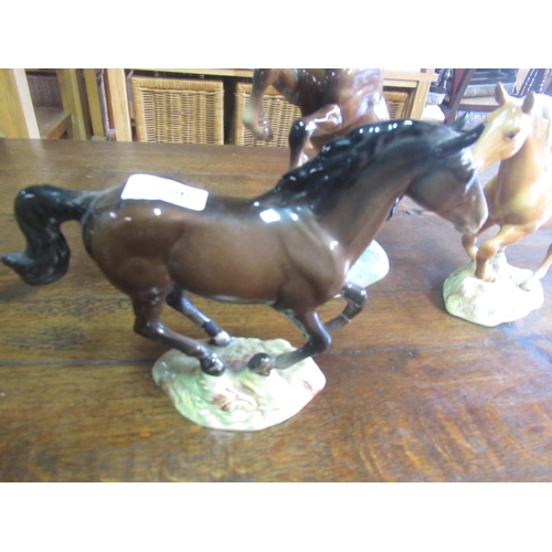 756 - Welsh cob rearing in brown gloss Two Beswick models of galloping horses, in brown gloss and palomino... 