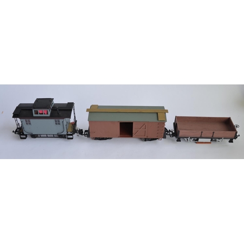 677 - 3 G-gauge railway wagons, 1 by Bachmann, 2 by Aristo including a track cleaning wagon. Both brown wa... 