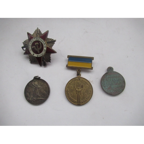 70 - Three Russian medallions, one of Bolshevik revolution, and Russian cap badge (4)