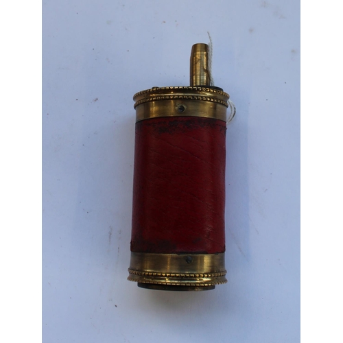 232 - Circular pistol powder flask with red leather cover