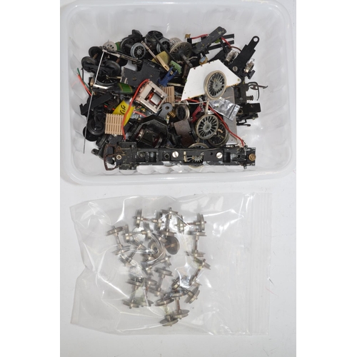 779 - A collection of OO gauge train parts, motors, spare wheels etc. Includes 2 heavily weathered static ... 