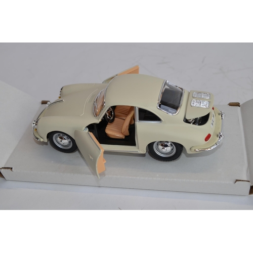 874 - 3 boxed 1/24 scale die-cast european car models:
A Danbury Mint 1964 Aston Martin DB5, box fair, no ... 