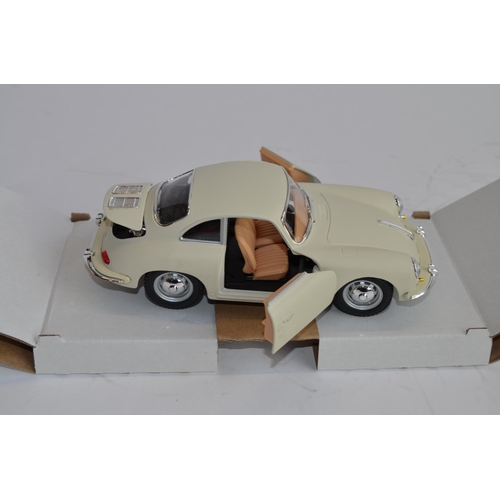 874 - 3 boxed 1/24 scale die-cast european car models:
A Danbury Mint 1964 Aston Martin DB5, box fair, no ... 