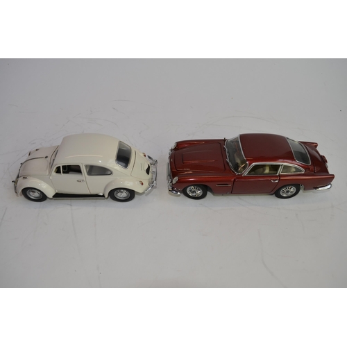 874 - 3 boxed 1/24 scale die-cast european car models:
A Danbury Mint 1964 Aston Martin DB5, box fair, no ... 