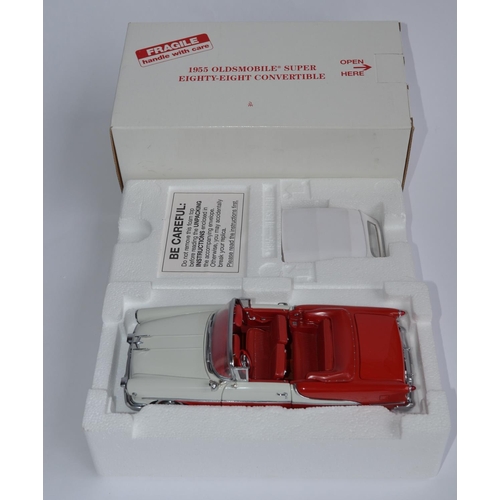 856 - A boxed Danbury Mint 1/24 diecast 1955 Super 88 Oldsmobile, red and polar white with certificate.