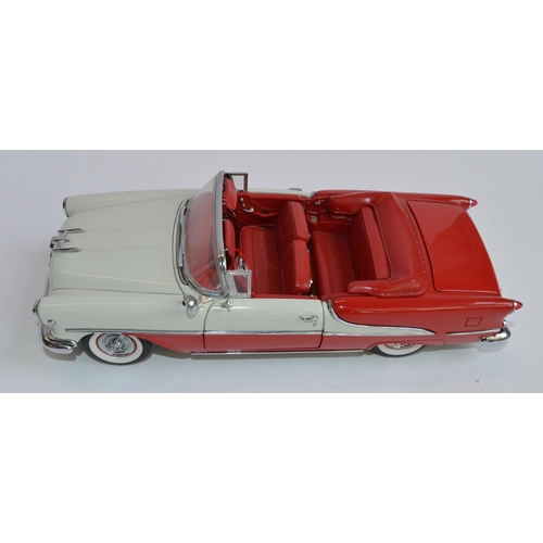 856 - A boxed Danbury Mint 1/24 diecast 1955 Super 88 Oldsmobile, red and polar white with certificate.