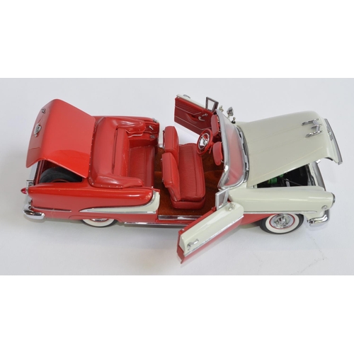 856 - A boxed Danbury Mint 1/24 diecast 1955 Super 88 Oldsmobile, red and polar white with certificate.