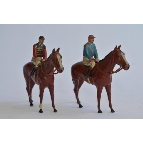 940 - 2 vintage Britains mounted jockey hollow lead figures with horses.