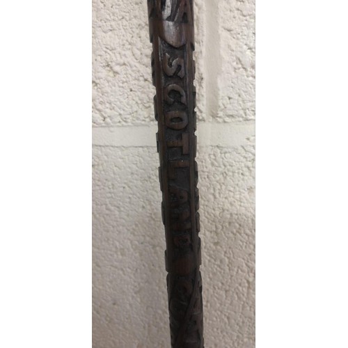 141d - A fruit wood carved swagger stick with engraving of 