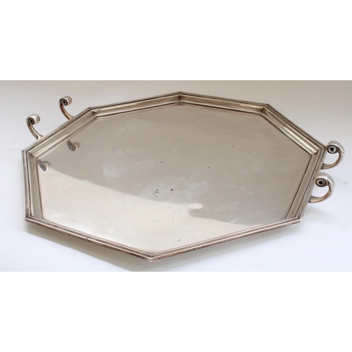 642 - Geo.V hallmarked silver serving tray, of art deco octagonal shape with stepped border and C scroll h... 