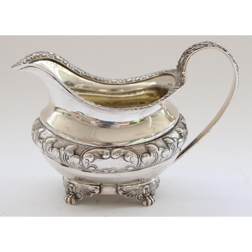 644 - Geo.IV hallmarked silver cream jug, body embossed with scrolled leaf pattern, handle and rim decorat... 