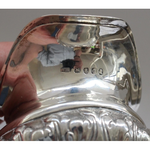 644 - Geo.IV hallmarked silver cream jug, body embossed with scrolled leaf pattern, handle and rim decorat... 