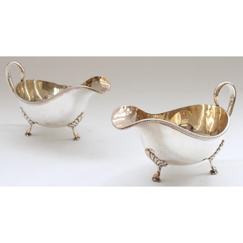 645 - Victorian pair of hallmarked silver sauce boats with button border on raised lion paw feet.  Sheffie... 