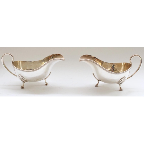 645 - Victorian pair of hallmarked silver sauce boats with button border on raised lion paw feet.  Sheffie... 
