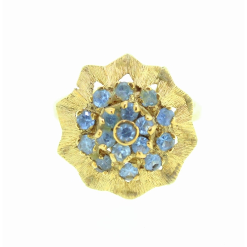 699 - Yellow metal cocktail cluster ring in starburst shape, ring set with aquamarines, no visible hallmar... 