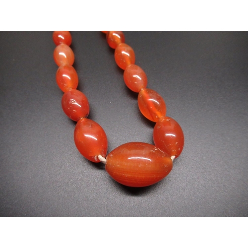 41 - Amber bead necklace, single row of oval graduated beads, largest approx L2.5cm, with screw closure, ... 