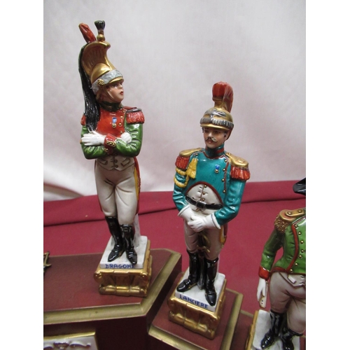 1154 - Set of six Naples Continental porcelain models of Napoleonic Soldiers, on stepped plinth, and anothe... 