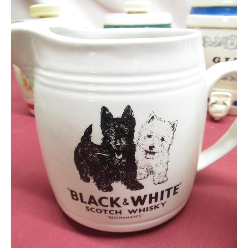 1170 - HCW Black and White whisky water jug, Wade Mackenzie  jug and a five Wade miniature Spirit barrels (... 