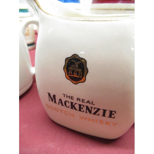 1170 - HCW Black and White whisky water jug, Wade Mackenzie  jug and a five Wade miniature Spirit barrels (... 