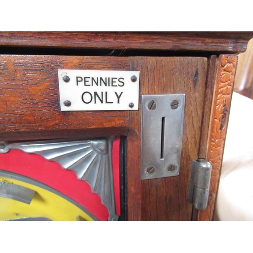 83 - 1960's oak cased Oliver Whales Penny in the Slot Alwin flicker machine, W45cm D18cm H63cm