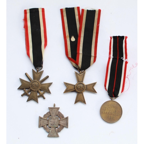 333 - Three German WWII period Third Reich war merit crosses with a 25 year faithful service medal