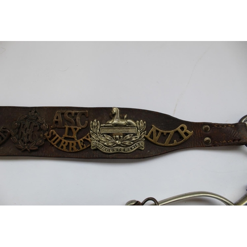 308 - WWI period leather belt, decorated with collection of military badges including RFC, Machine Gun Reg... 