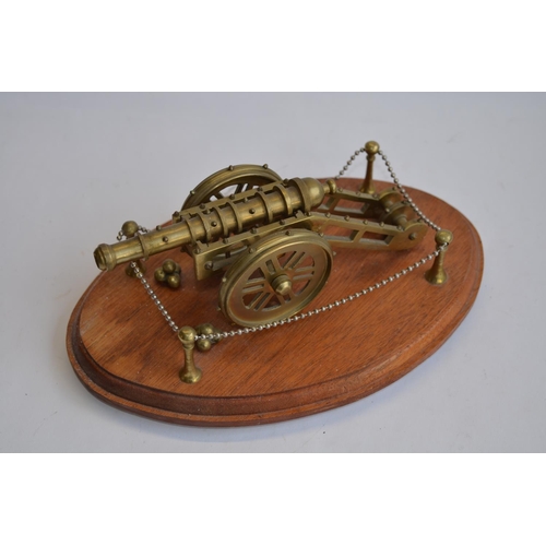 277 - 2 cast metal model cannons (non-firing), one on a base.
Larger cannon size approx 28cm long x 18cm w... 