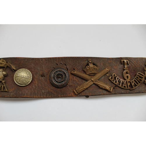 308 - WWI period leather belt, decorated with collection of military badges including RFC, Machine Gun Reg... 