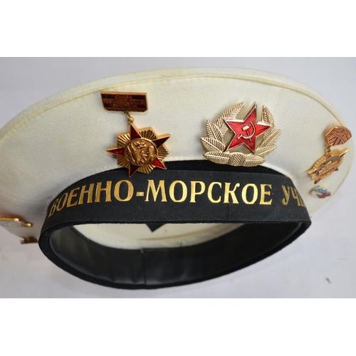 292 - A collection of mostly Russian caps with a large number of badges attached, many naval and parachute... 