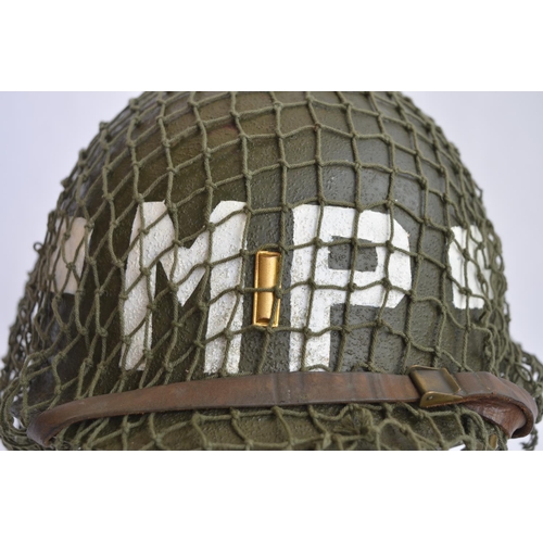 472 - A US Army WWII M1 Mk1 front seam steel helmet, with liner, chin straps etc. With 2nd Lieutenant bar ... 