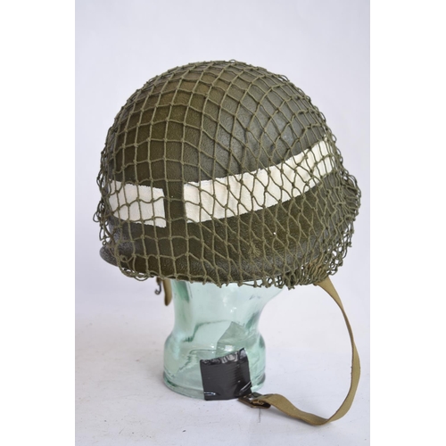 472 - A US Army WWII M1 Mk1 front seam steel helmet, with liner, chin straps etc. With 2nd Lieutenant bar ... 