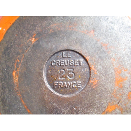 128 - Pair of Le Creuset volcanic orange cast iron round skillets, no. 16, D16.5cm, larger skillet no. 23,... 